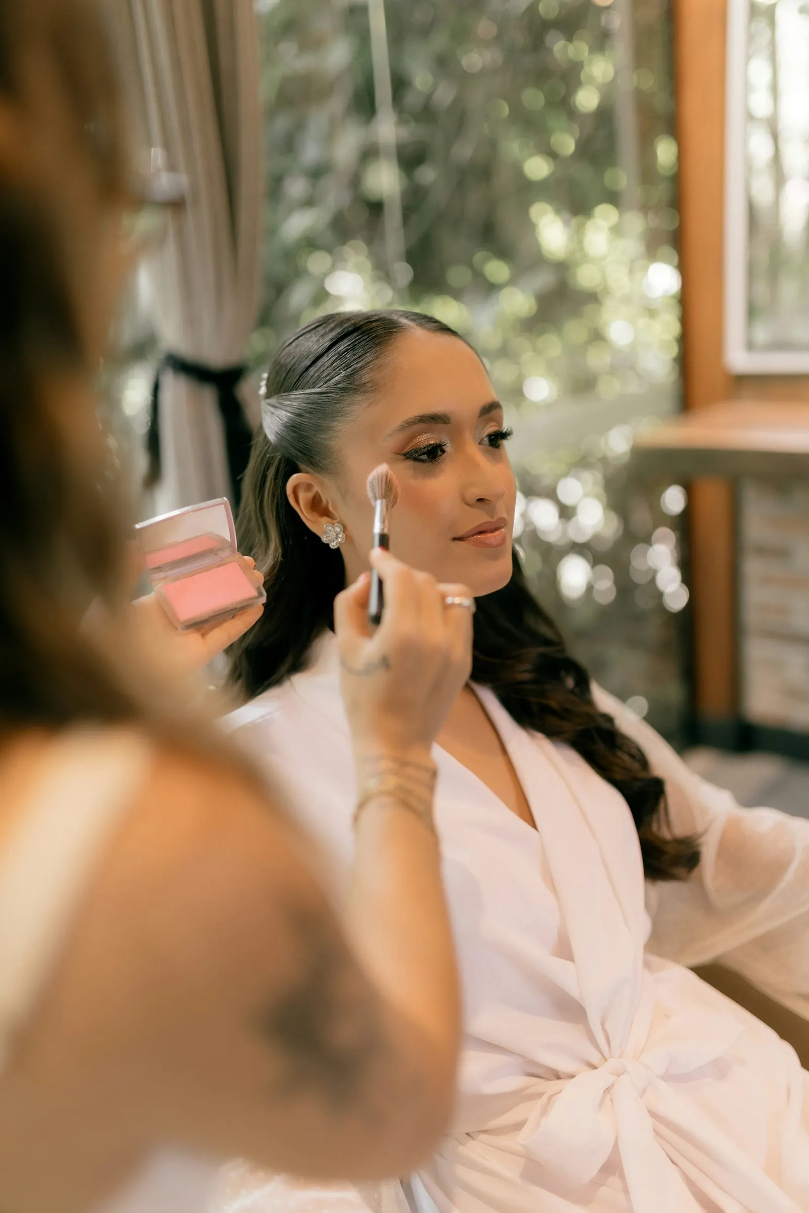 A bride having her make-up applied